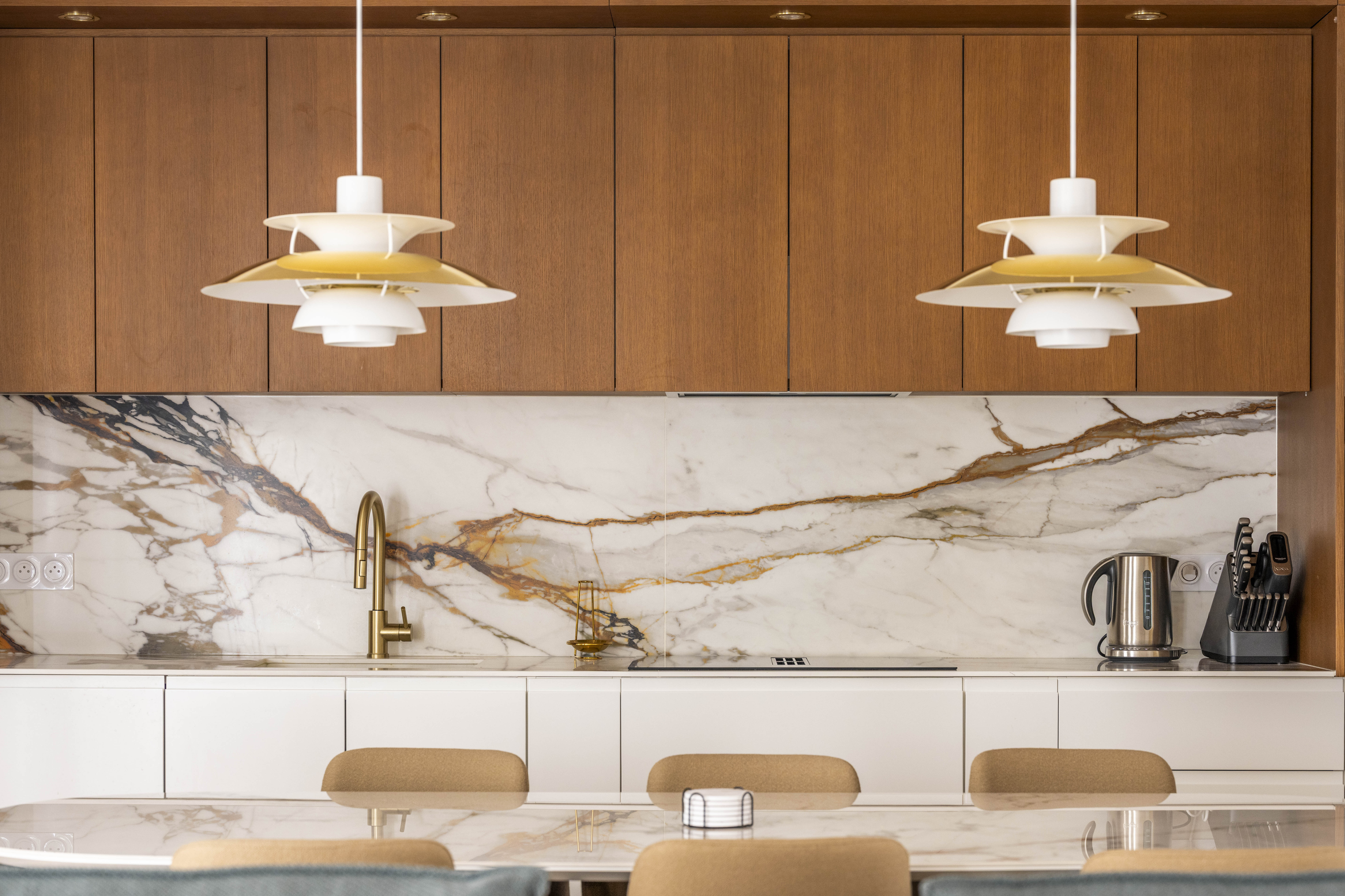 Kitchen with Calacatta marble and PH pendants