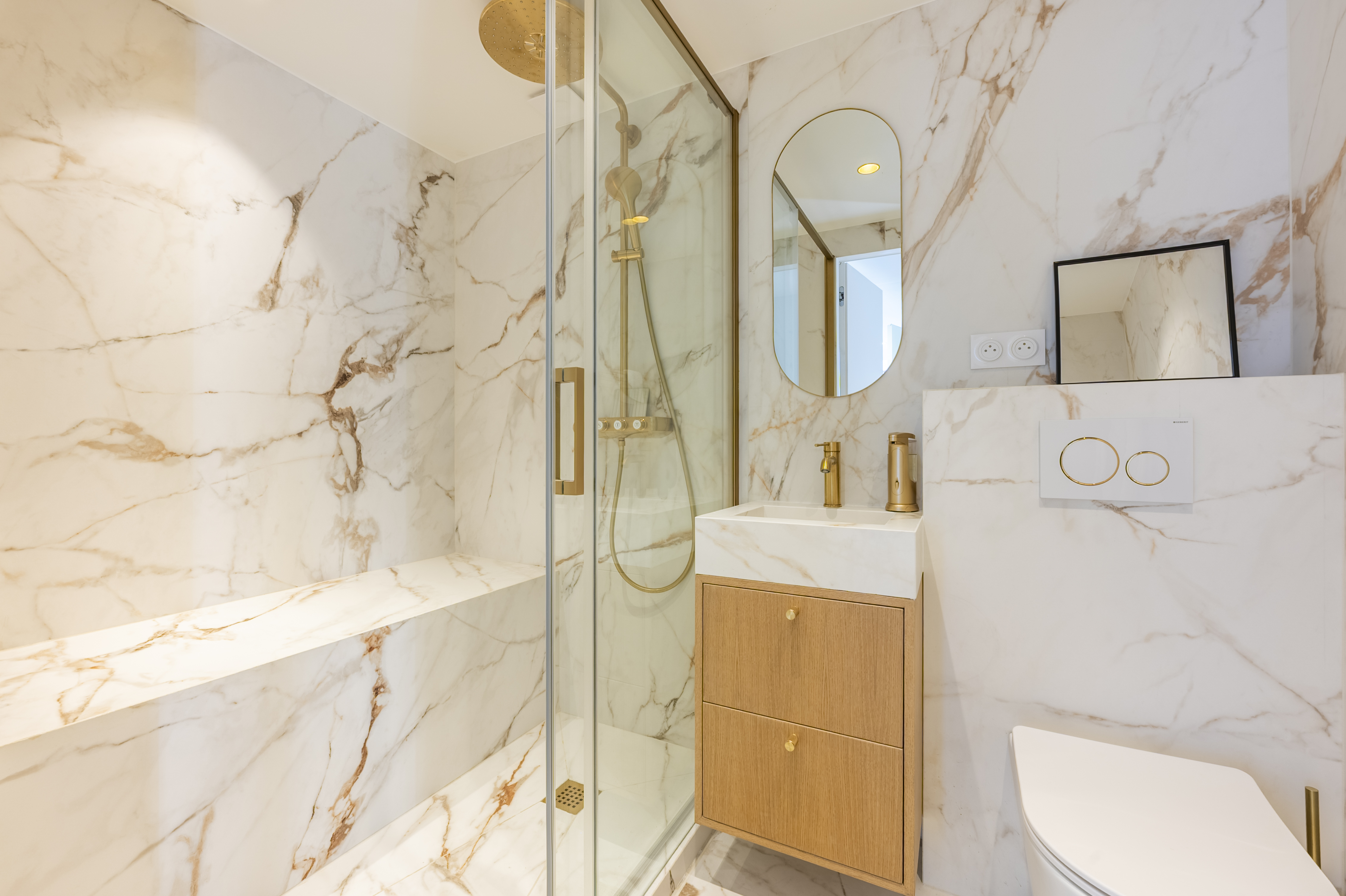 White marble bathroom with gold fixtures